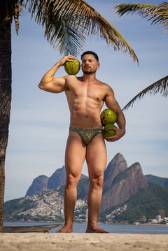 Model wearing Bikini Caio Brazilian swim brief in Astro Moss (olive green)